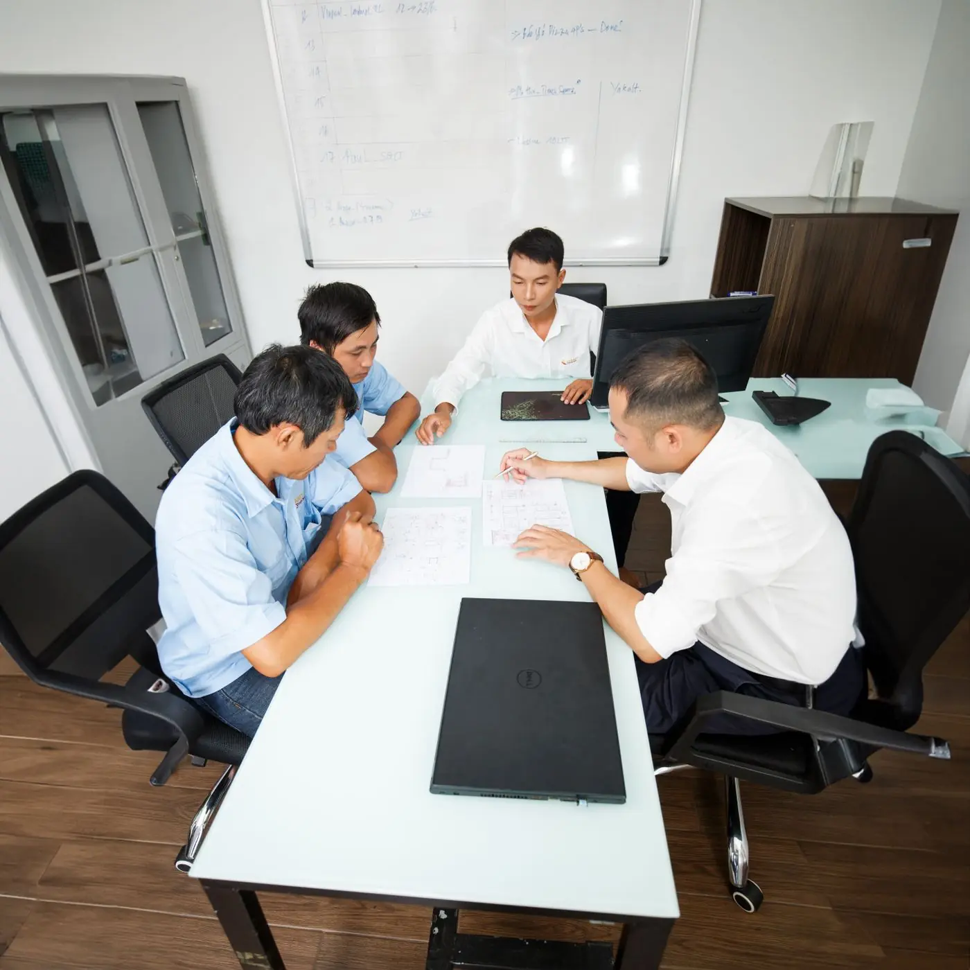 Advisors discussing a case file around a meeting table